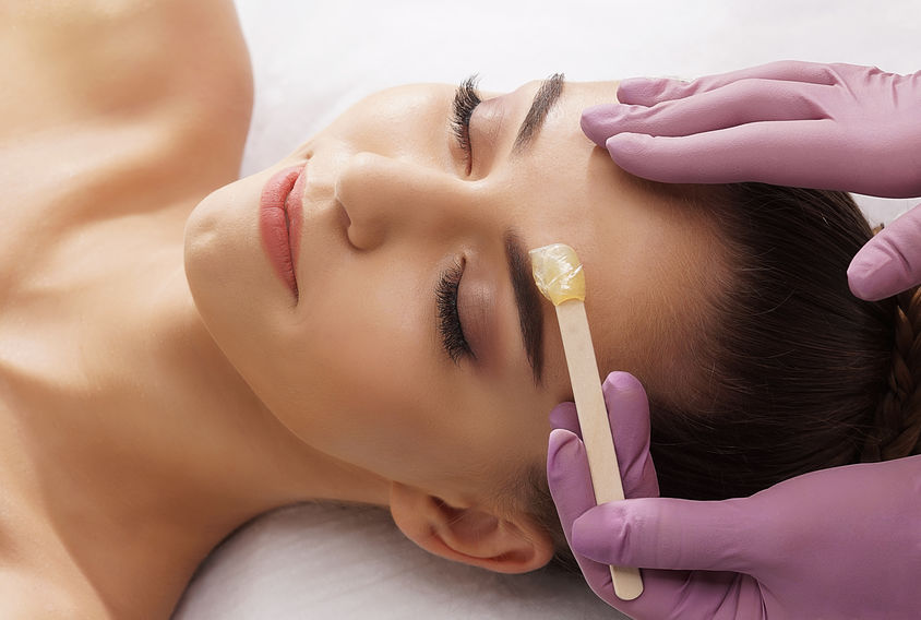 beautiful female face with hot wax
