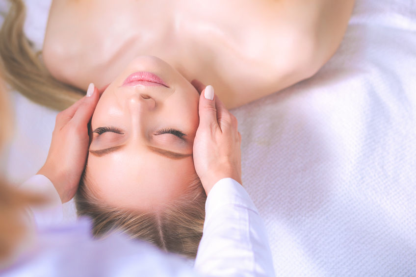 Young woman getting a facial massage