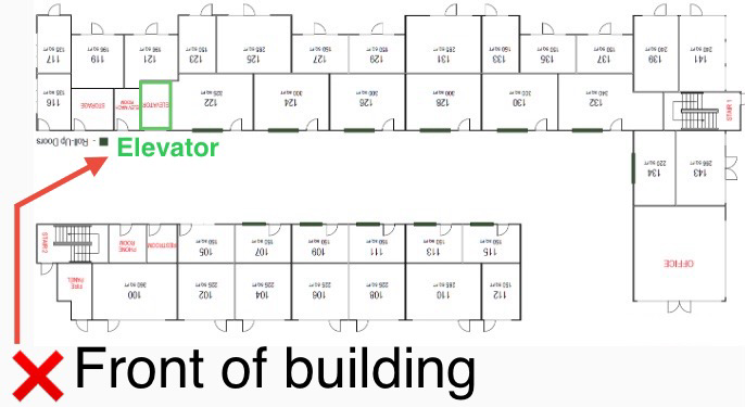 Floor plan diagram showing room numbers, an elevator, and the building's front entrance marked with a red cross and arrow.